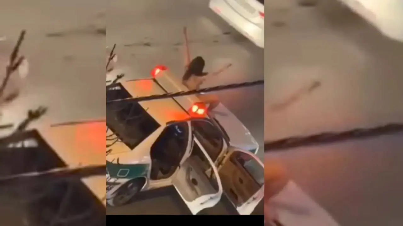 امرأة عارية فوق سيارة شرطة في إيران