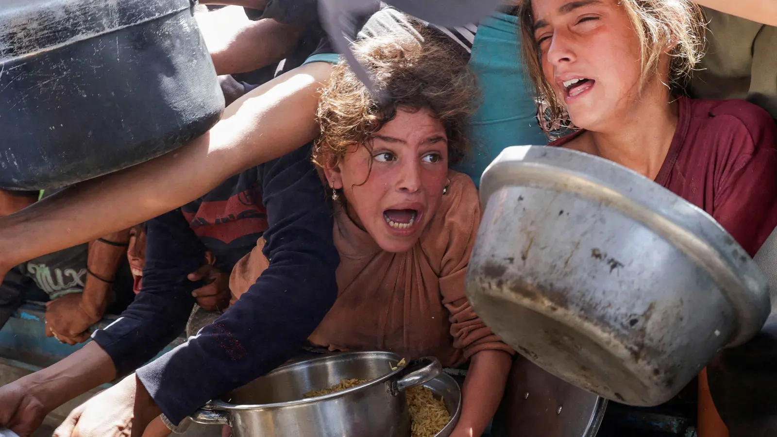 أطفال يتدافعون للحصول على طعام خيري في غزة