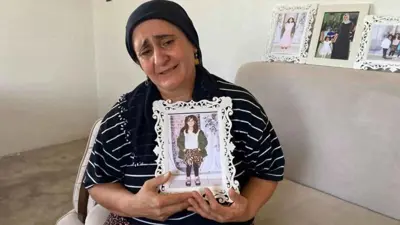 والدة الطفلة نارين تحمل صورتها